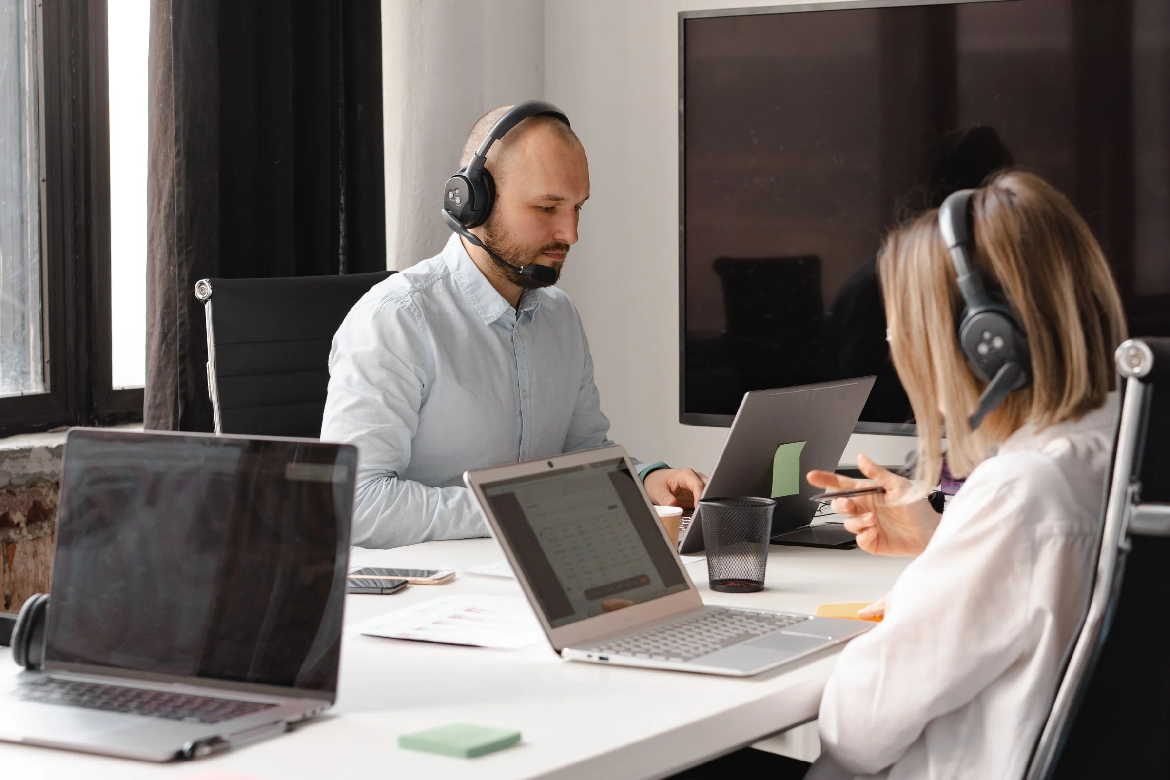 Support team helping a customer from an office